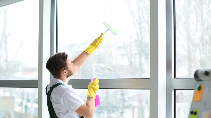 man working on a commercial window cleaning portland tn